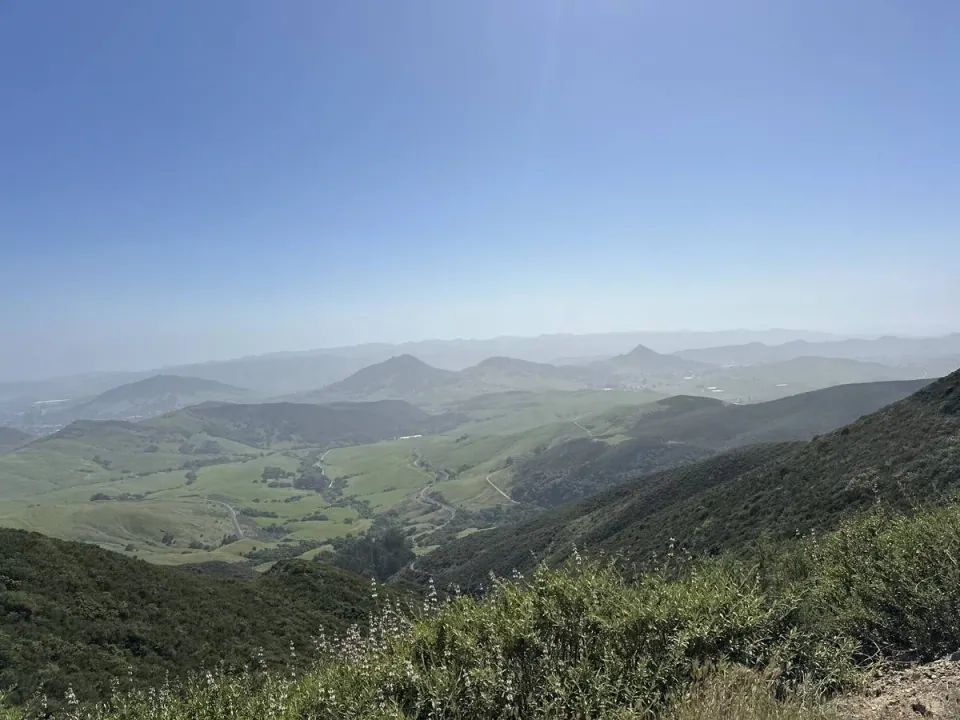 Green ridges folding toward distant peaks