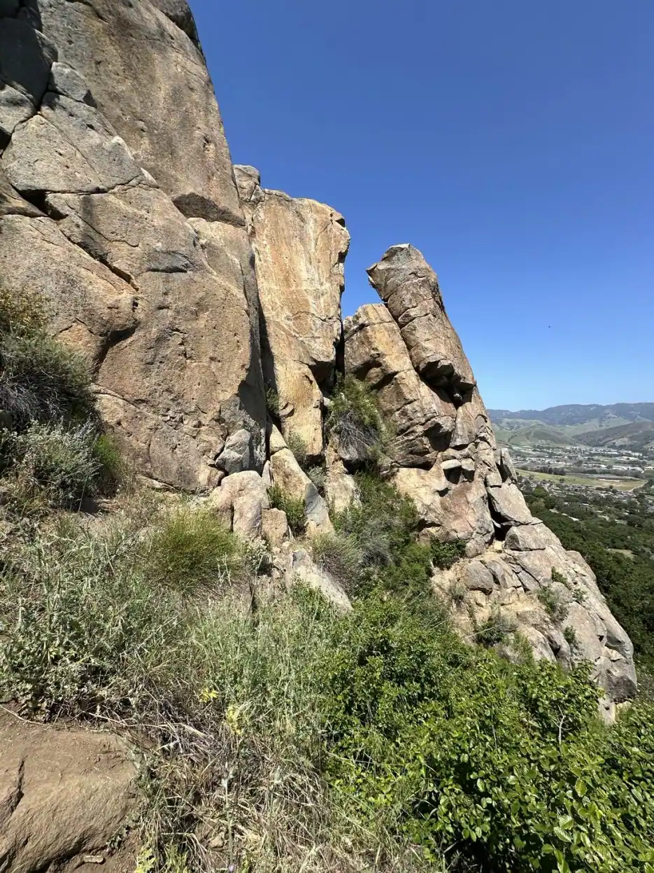 Volcanic rock outcrop rising above the valley floor