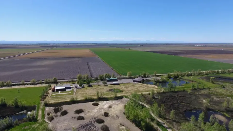 Aerial view of patchwork valley farmland to the horizon