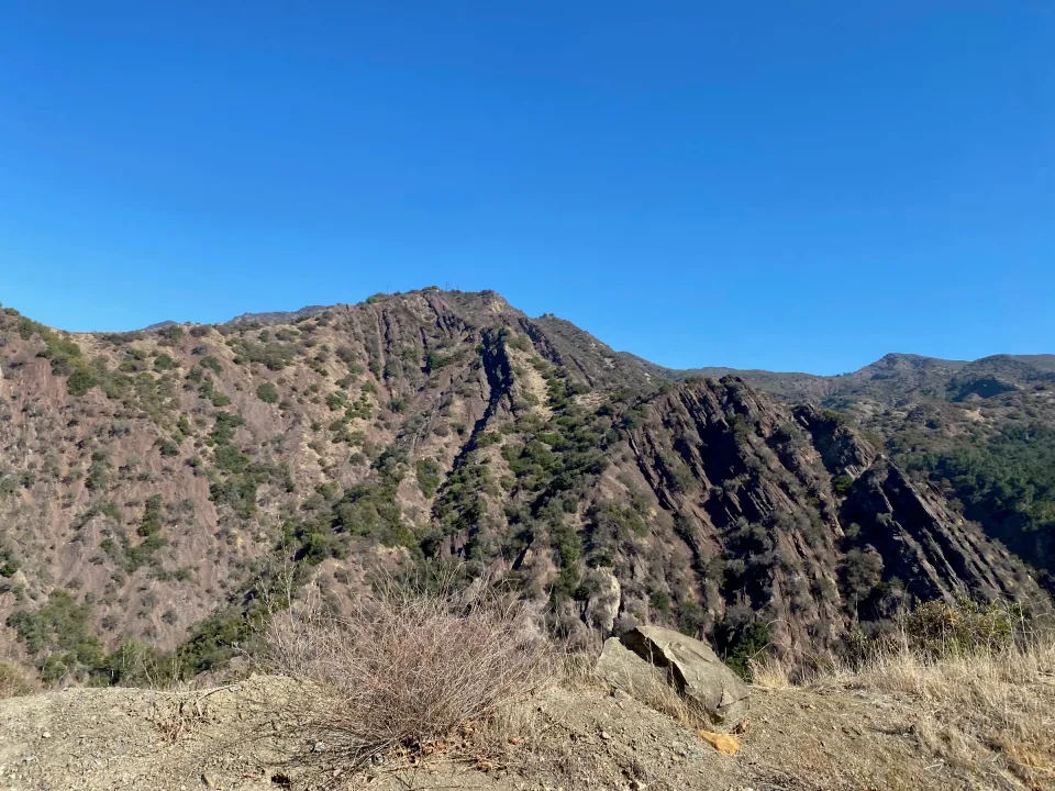 Rugged rocky mountain ridge under a clear blue sky