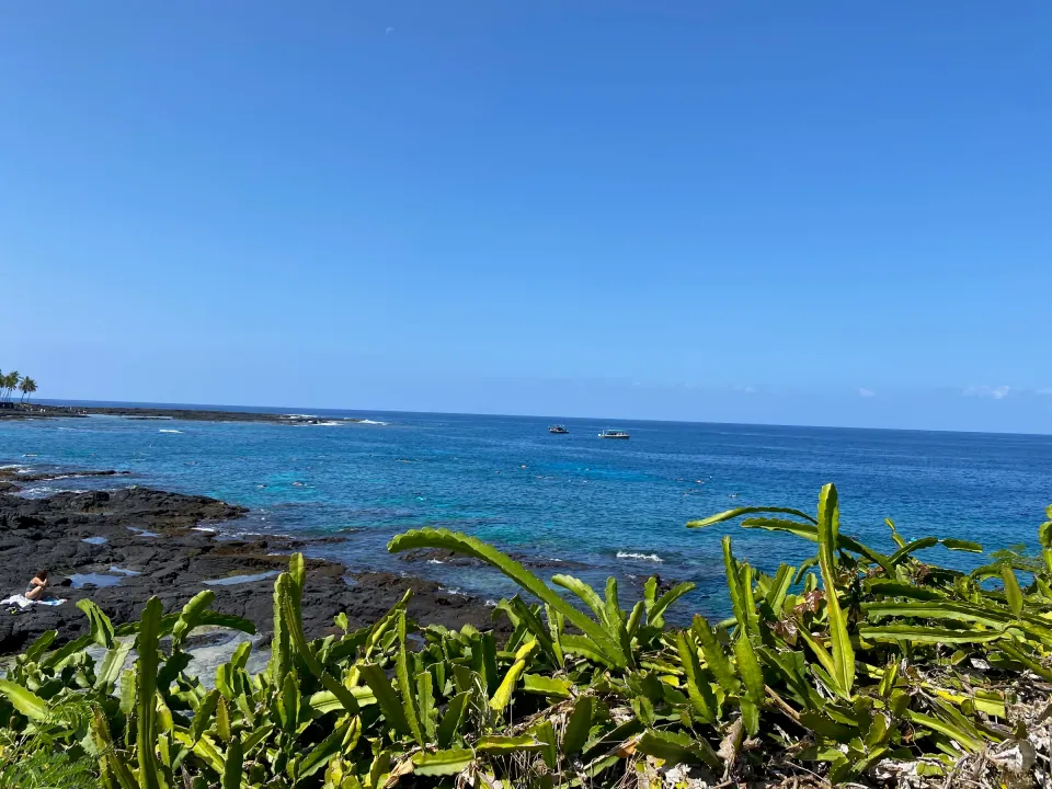 Kona lava coastline and deep blue ocean under clear sky
