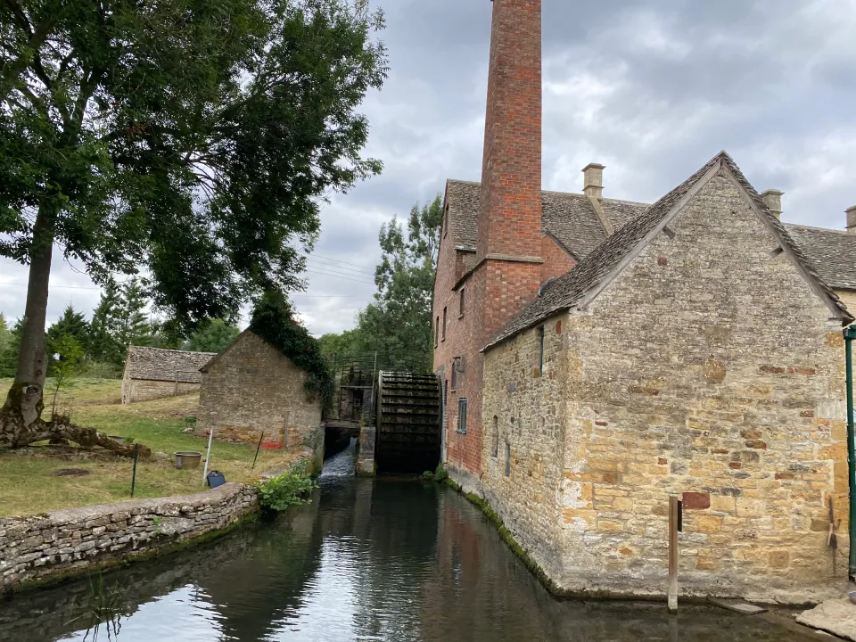 Lower Slaughter stone mill and waterwheel beside stream