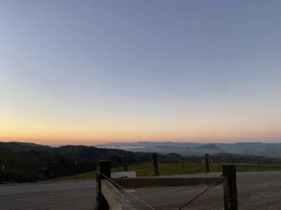 Ranch road and fence at dusk