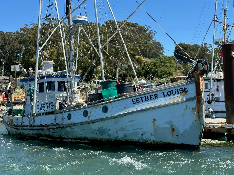 Weathered wooden fishing boat moored in a harbor