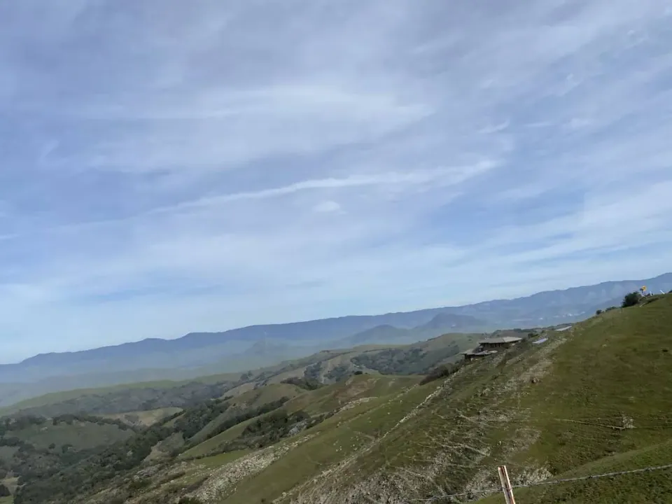 Ridge road with green hills falling away toward the valley