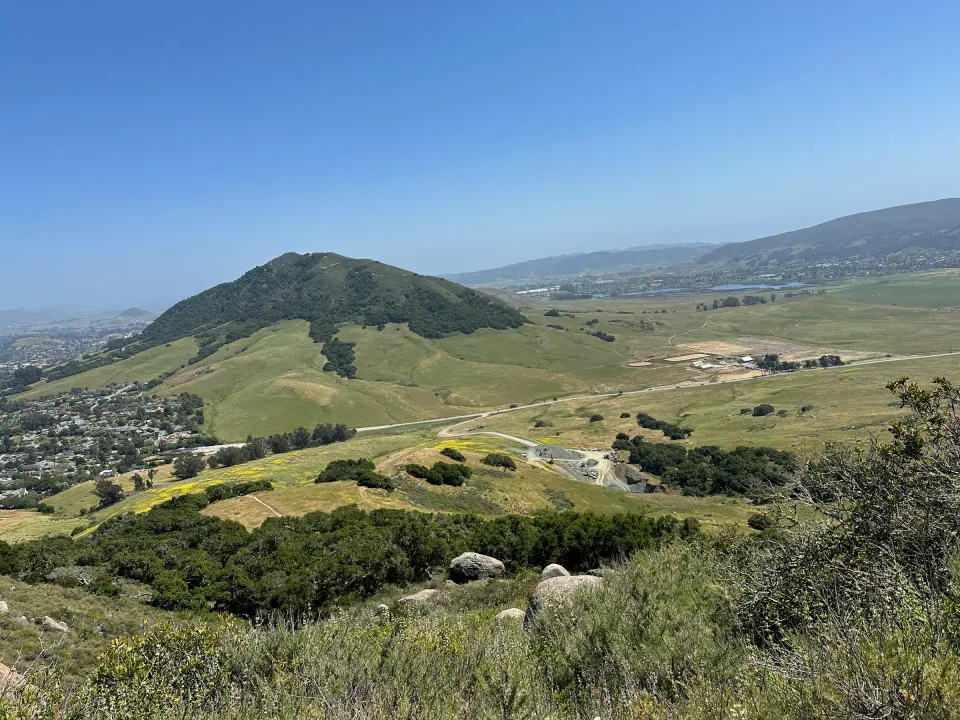 Hillside view across green spring hills and the valley