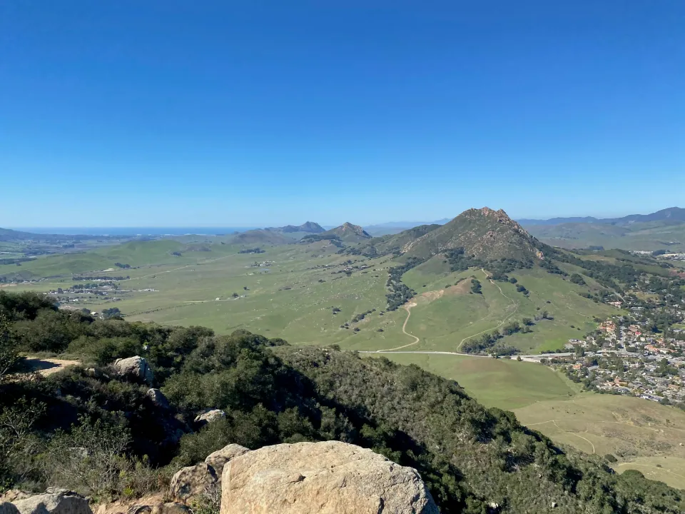 Green valley and the chain of peaks seen from a rocky summit