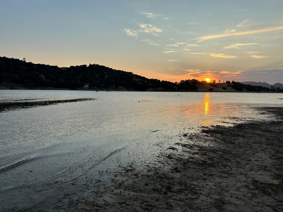 Sun setting over a still lake