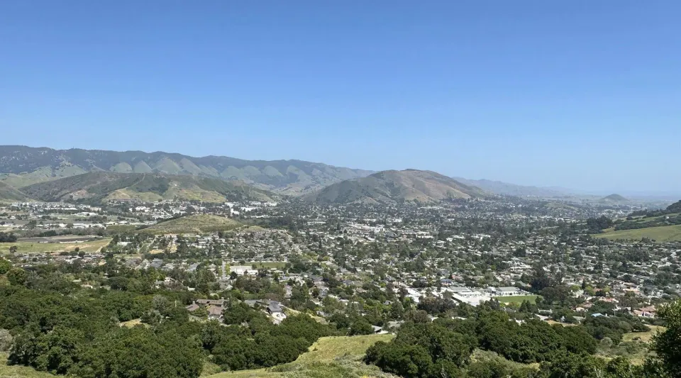 A Central Coast town spread across its valley, seen from the hills above